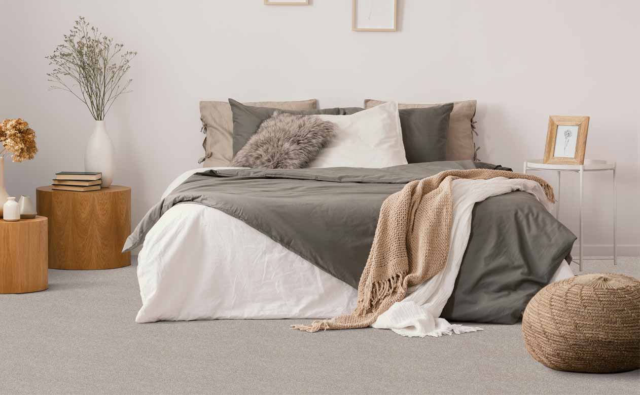 Bedroom with bed and grey carpeted floors